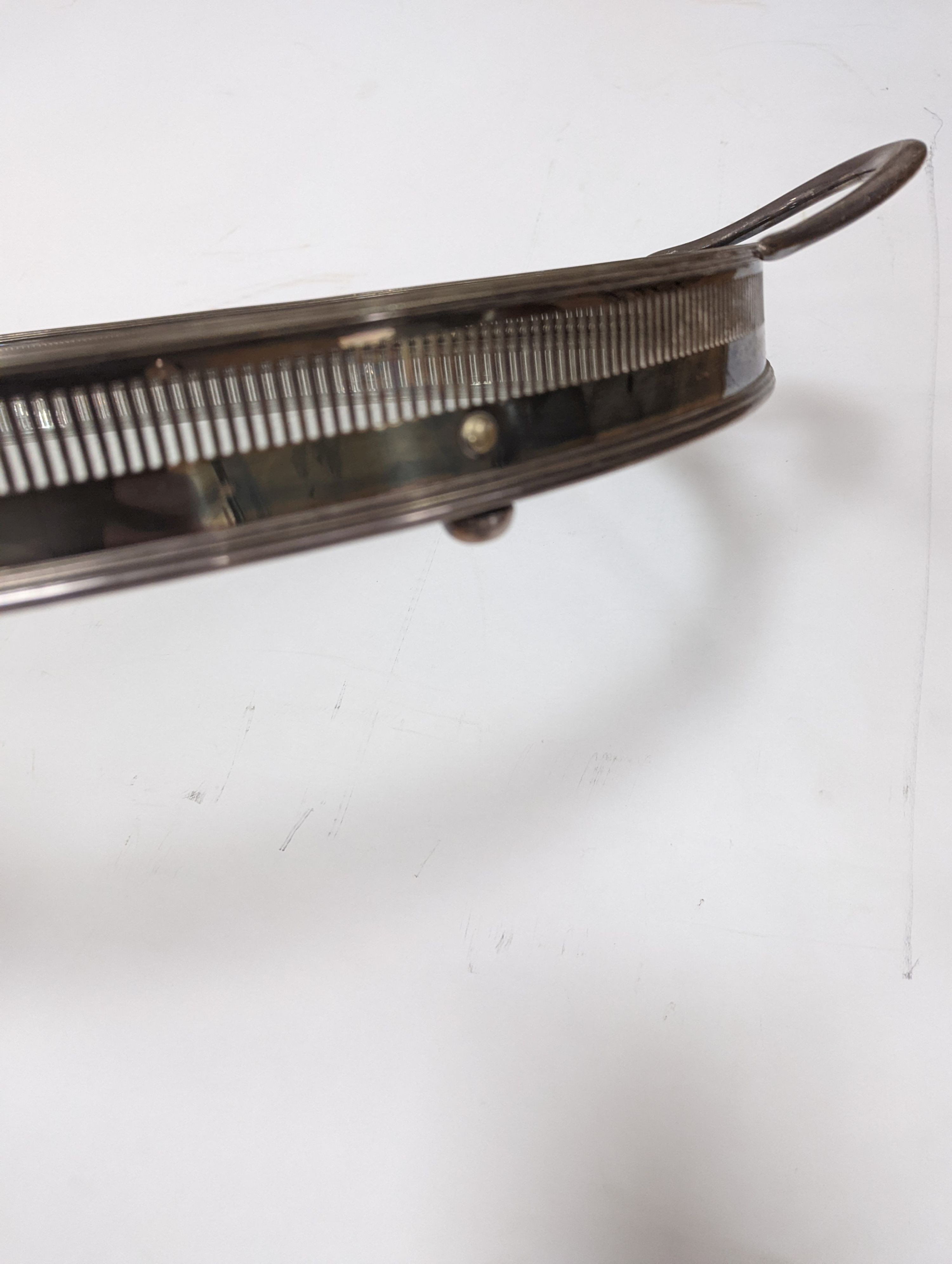 A silver plated and glass gallery tray 77cm